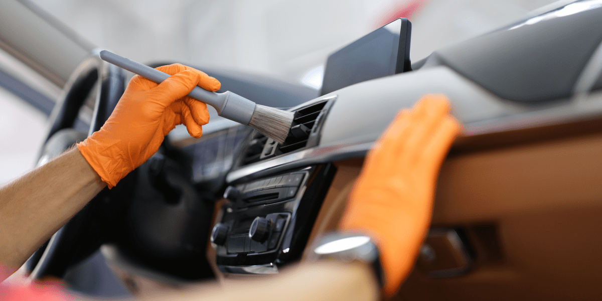 man-car-wipes-dust-with-brush 1
