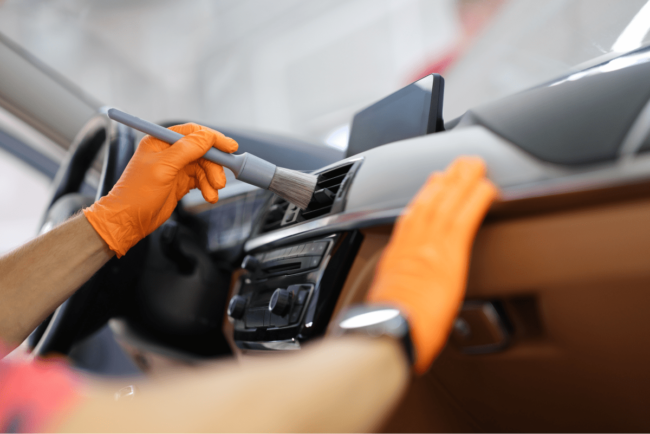 man-car-wipes-dust-with-brush 1
