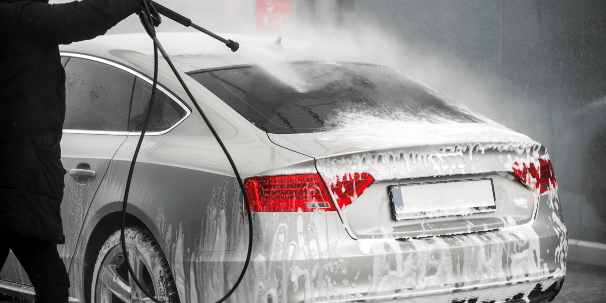 man-washing-his-grey-car-high-pressure-water-outdoors-back-view (1) 1